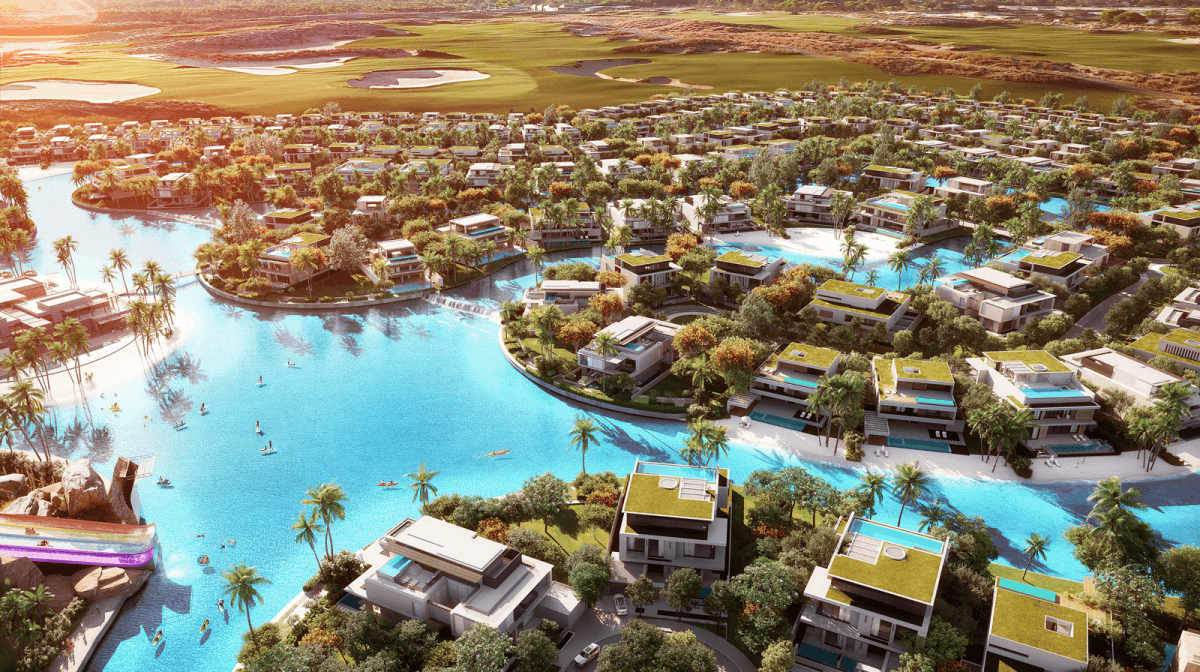 Top view of Azizi Venice at Dubai South, featuring a large pool surrounded by luxury villas, green spaces, and family-friendly living amenities.