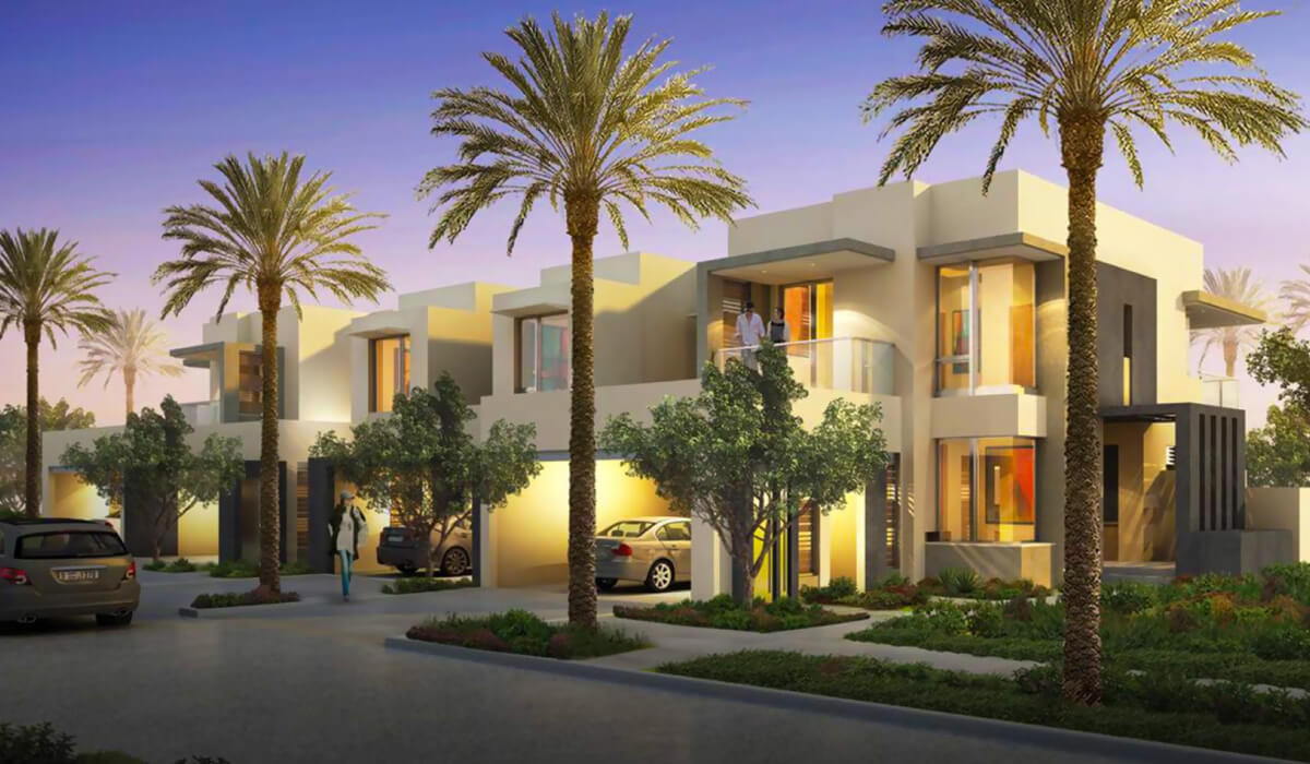 A quiet neighborhood street in Dubai Hills at dusk, illuminated by soft yellow lights. A person walks home past modern buildings, creating a sense of comfort and tranquility.