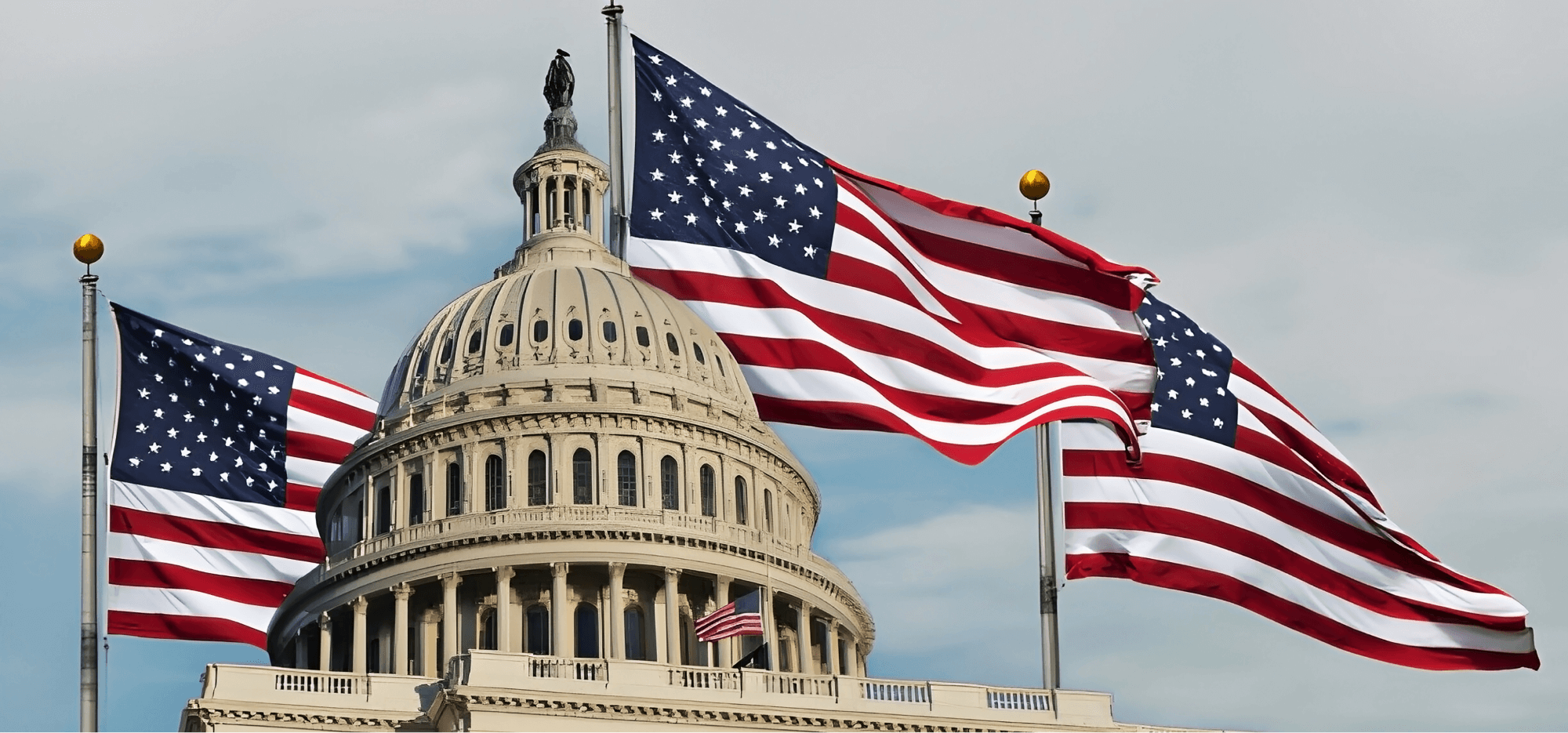  The roof of the Washington White House features three large flags and one smaller flag, all waving in the wind against a bright blue sky.