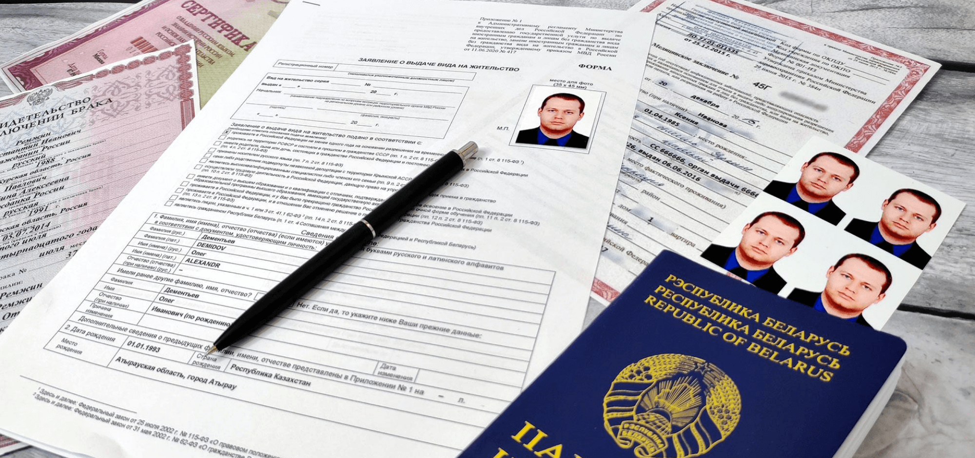  A foreign passport alongside passport-size photos and documents spread out on a table, symbolizing the process of applying for Russian residency.