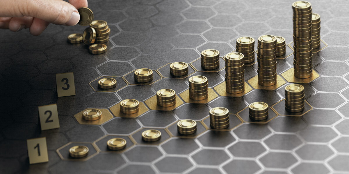 A strategic game board with hexagonal patterns, where a hand is carefully stacking golden coins on specific cells, symbolizing investment, strategy, and calculated growth in wealth accumulation.