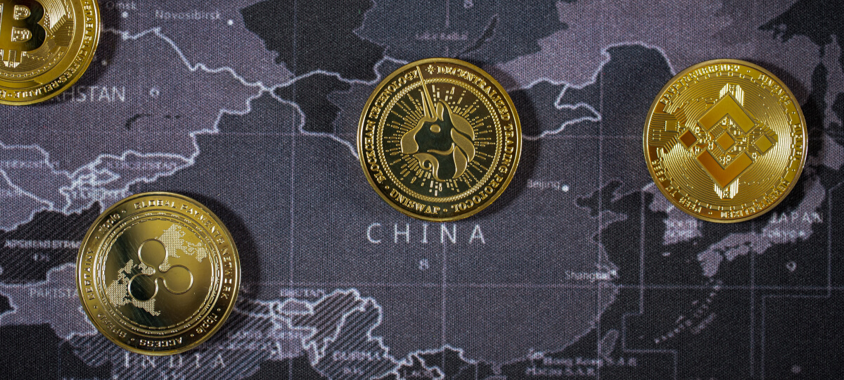 Digital coins, including Ripple and Uniswap, placed on a map highlighting China, symbolizing crypto influence in the region.