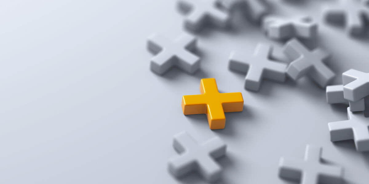 A standout yellow cross among grey crosses on a minimalist background.