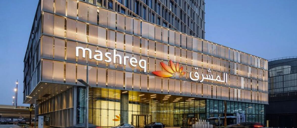 A large sign of Mashreq Bank, with its logo and Arabic text visible on the building.