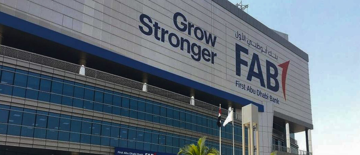 A large "FAB" sign for First Abu Dhabi Bank, with the slogan "Grow Stronger" on the building.