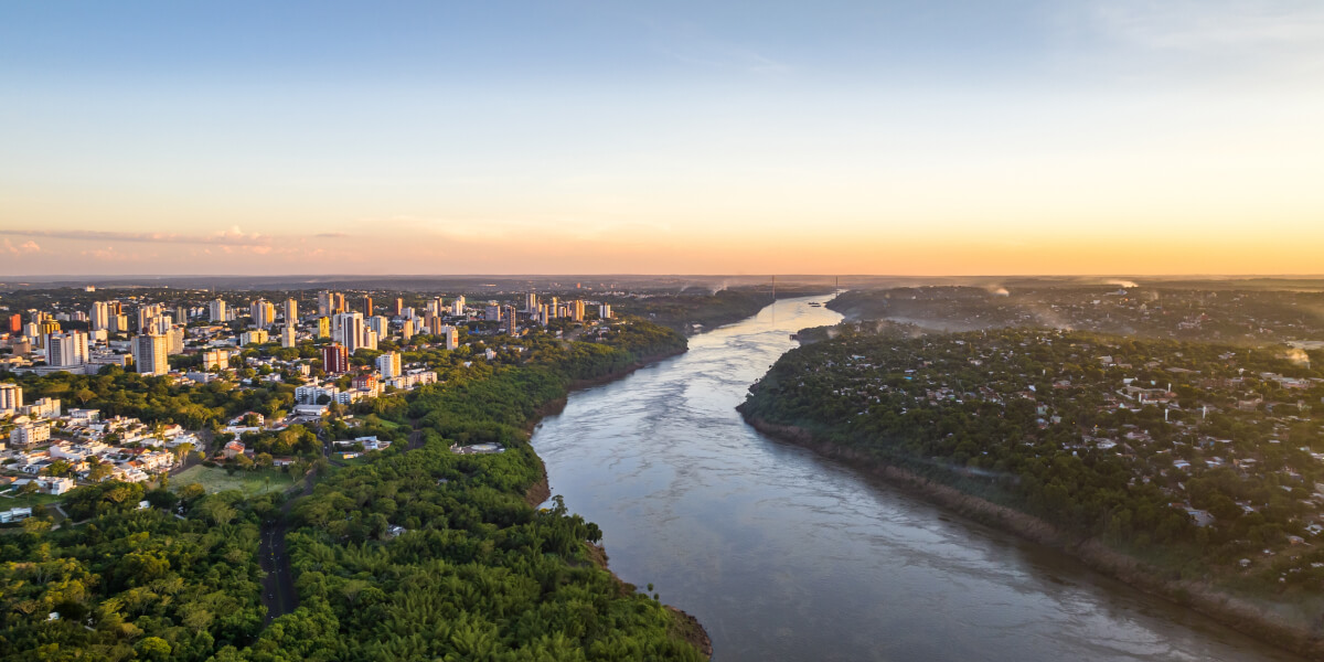 Cityscape by river at sunset, Paraguay