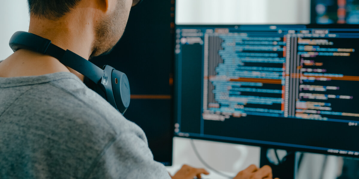 Man with headphones coding