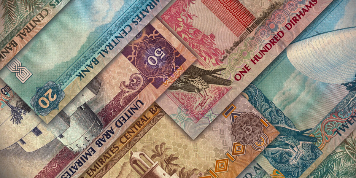 Stack of colorful UAE Dirham banknotes in various denominations.