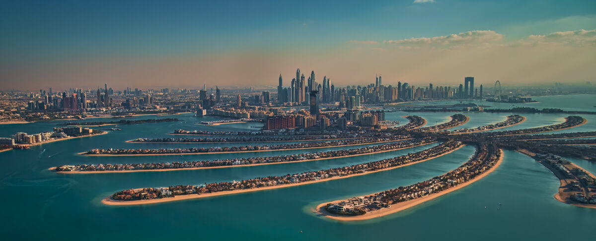 Aerial view of Palm Jumeirah with skyline and frond villas.