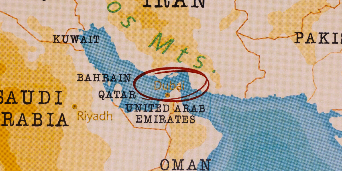 Map of the Arabian Gulf region with Dubai circled in red, showing nearby countries like Saudi Arabia, Qatar, and Kuwait.