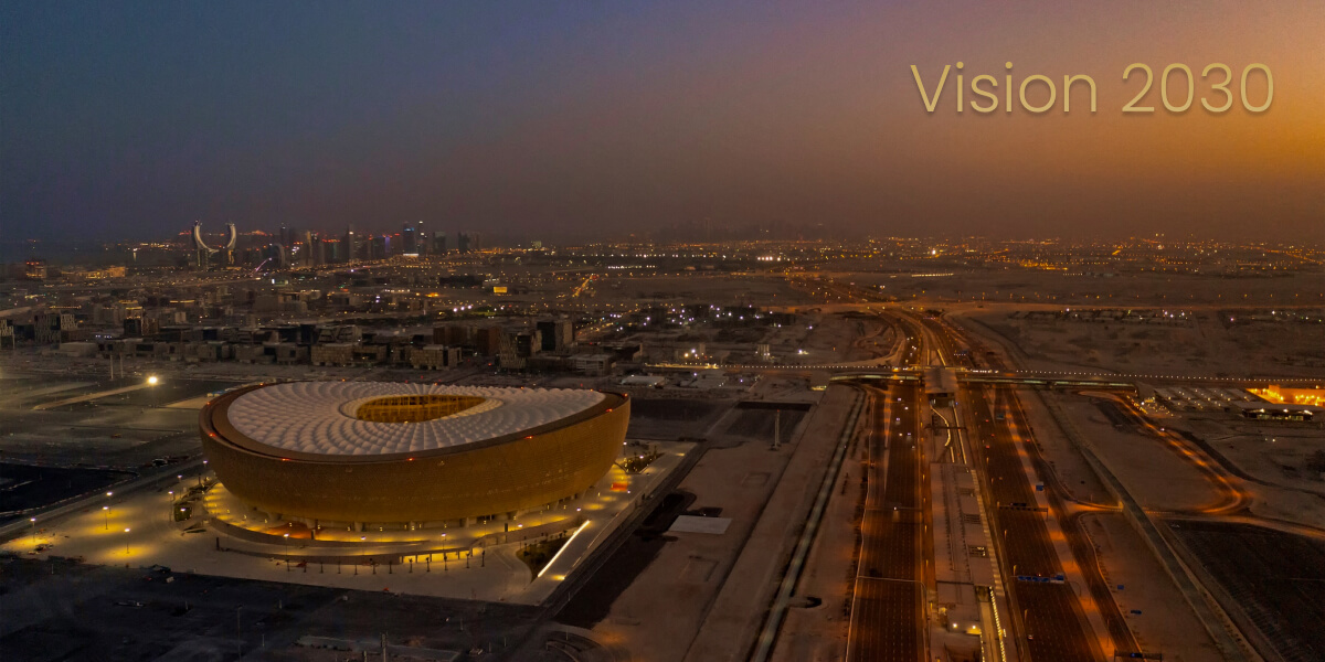 Aerial dusk view of Lusail Stadium and Lusail City skyline in Qatar.