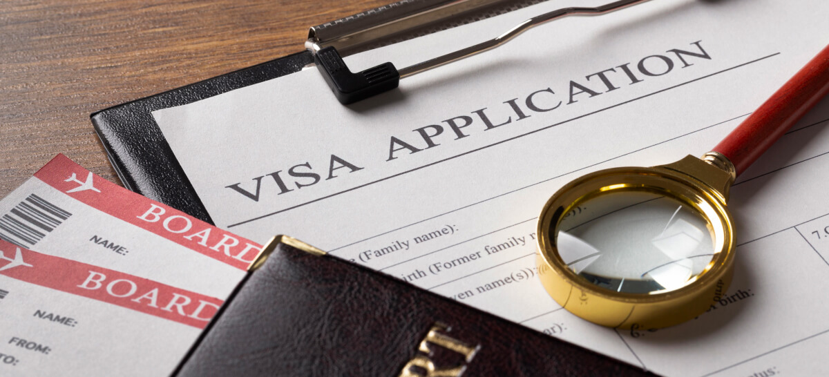 Visa application form next to boarding passes and a passport
