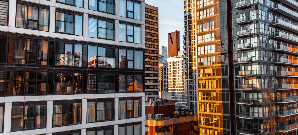 Glass apartment buildings reflecting the city skyline