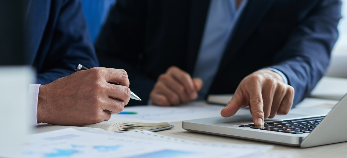 Close-up of businessperson writing notes during a meeting